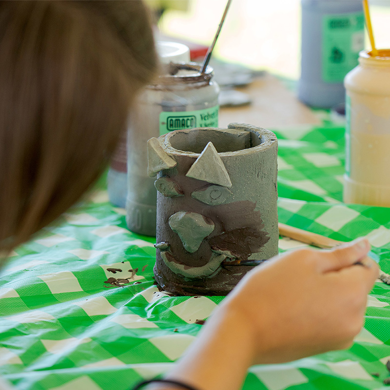 A person creating a clay form