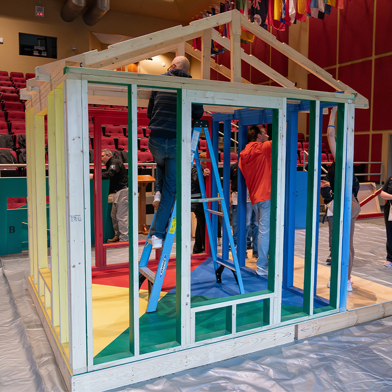 People building a mini house.