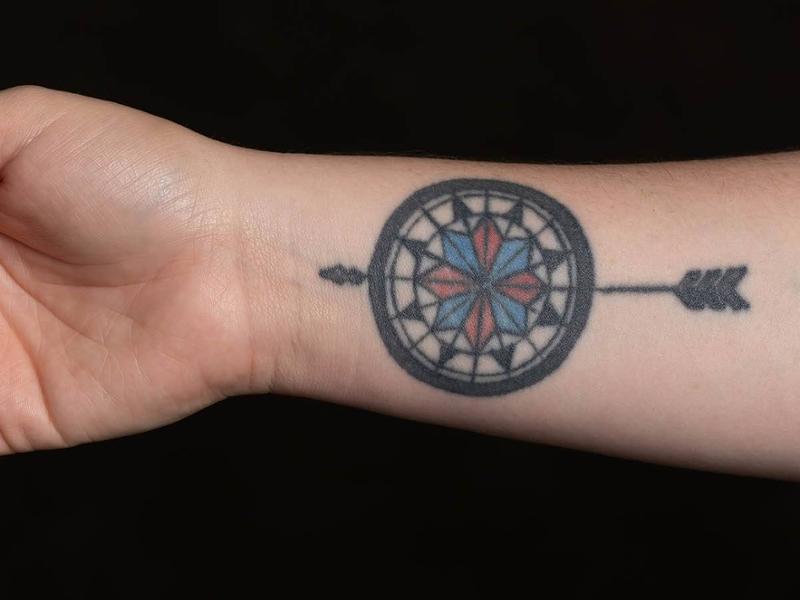 This image shows a tattoo with an arrow.